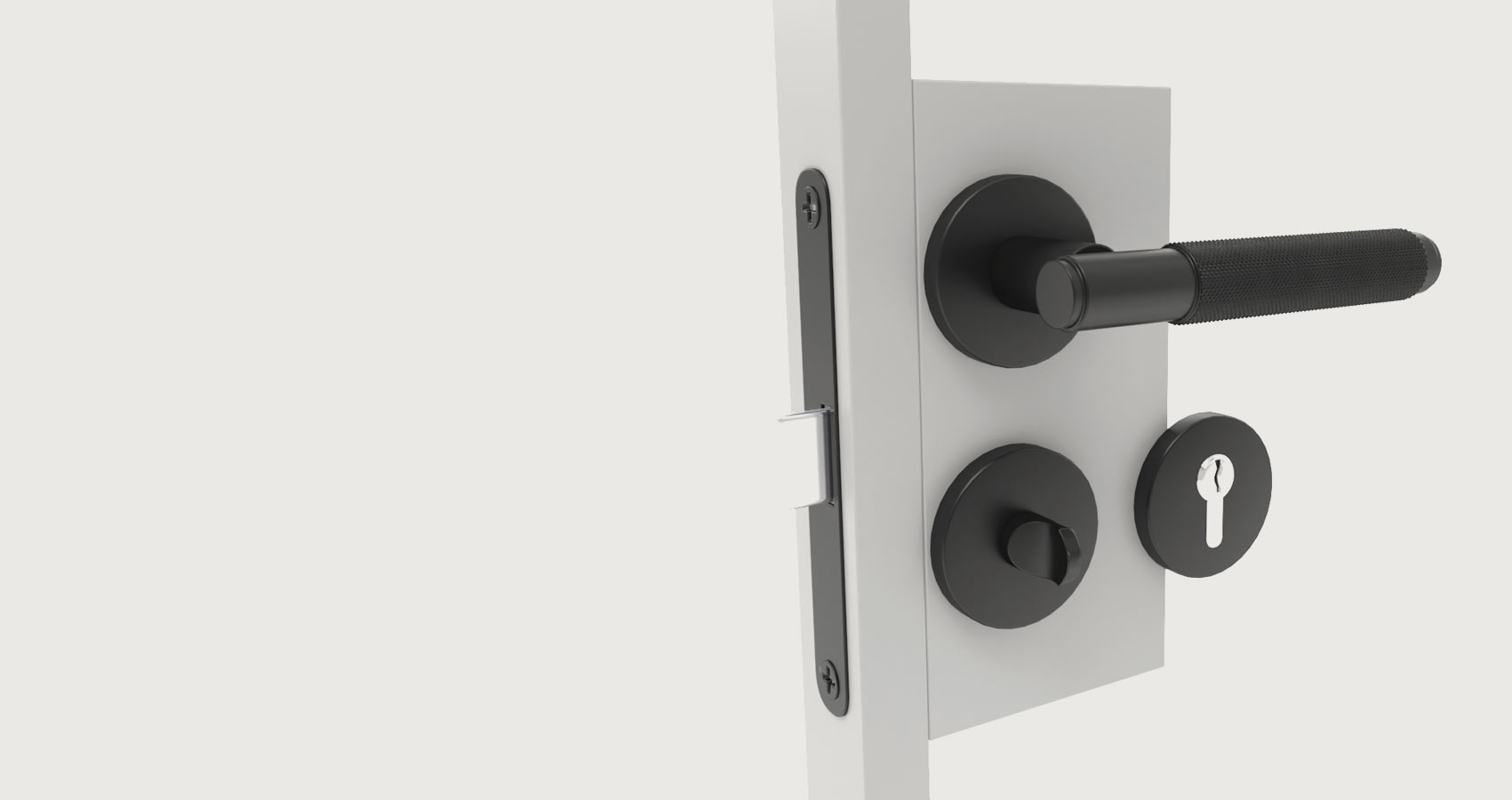 Schwarze Türgriffgarnitur mit rundem Schlüssel- und Drehknauf an weißer Tür. Schwarze Türgriffgarnitur mit rundem Schlüssel- und Drehknauf an weißer Tür.